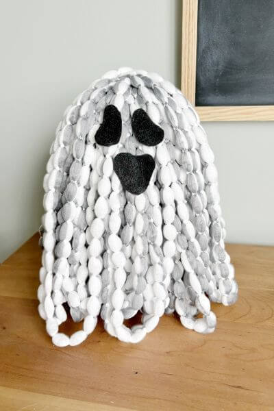 Microfiber grey mop head ghost with eyes and mouth added. 