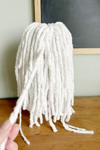 Pull out the rope strands a bit on this taller ghost on each side so the mop head covers the bottle. 