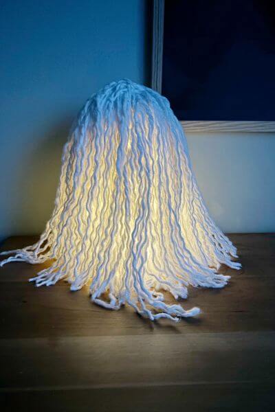 Ghost mop head lighted up at night without eyes and mouth added. 