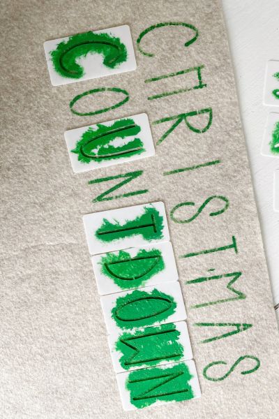 Green paint applied to the stencils to put the word "Countdown" on the felt. 