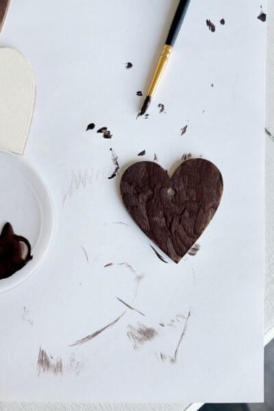 Paint the wood heart with craft paint and paintbrush.