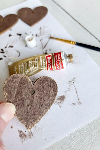 Gold brushed onto edges of wood heart.