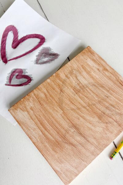 Heart shapes transferred onto the painted canvas.