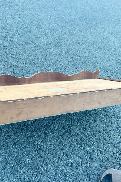 Re pound the nails into the desk to secure the bottom of the drawer. 
