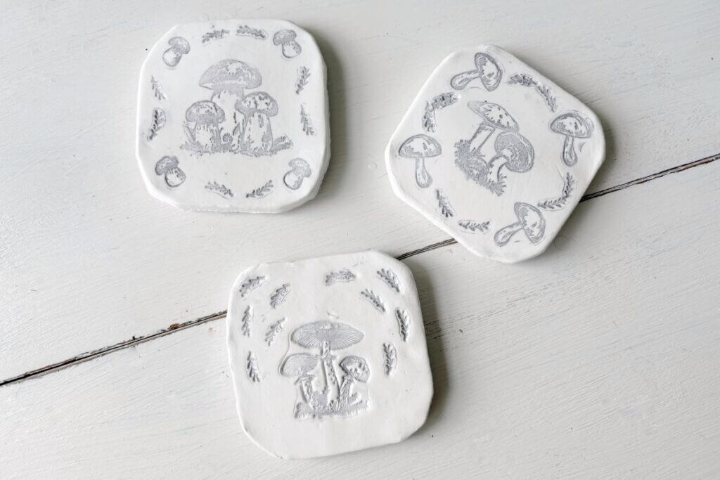 Three air dry clay coasters with mushroom prints.