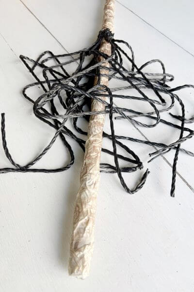 One layer of poly rope hot glued around broom handle. 