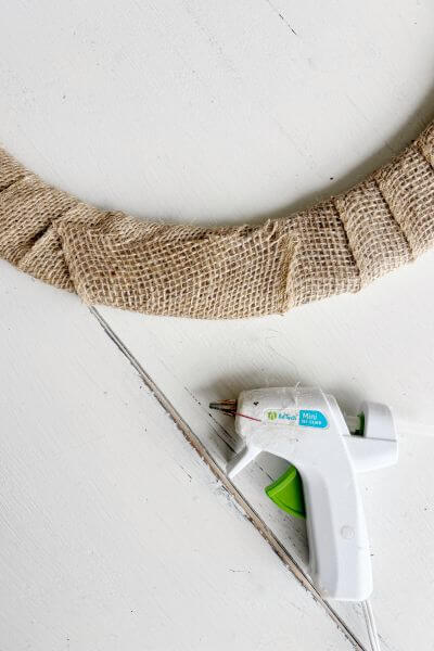 Once the burlap is wrapped all around the form, hot glue it in the back. 