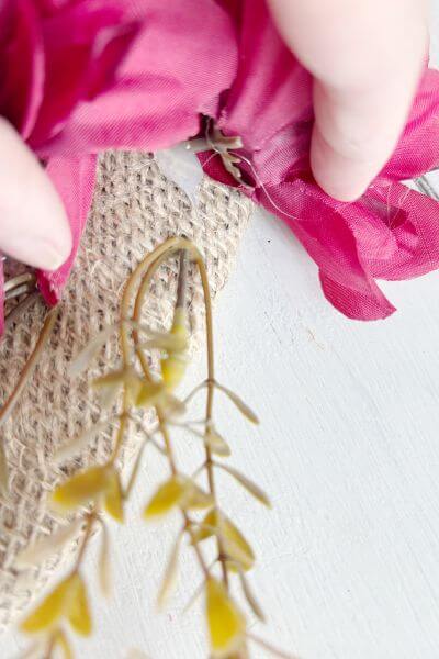 Tuck the wildflower stem into the burlap. 