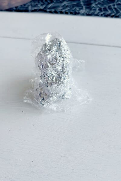 Aluminum foil form covered with plastic wrap.