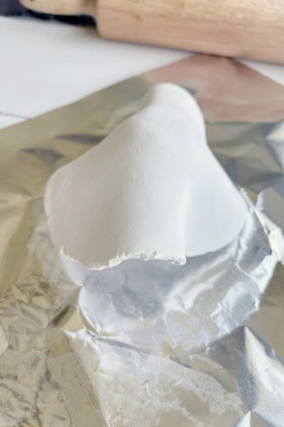 Drape the rolled-out clay over the tin foil form. 