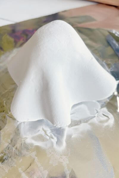 Gently form the clay making waves to look like a ghost's sheet.