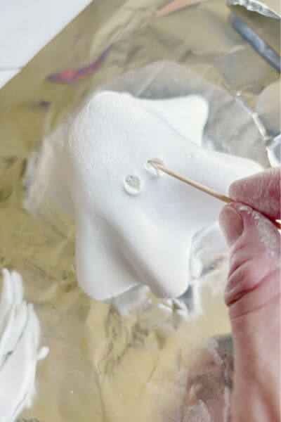 Make the eyes and nose of the ghost using a toothpick. 