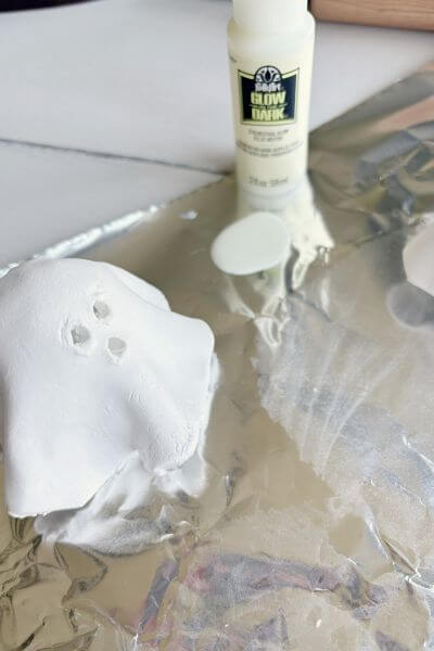 Apply glow in the dark paint to your clay ghost. 