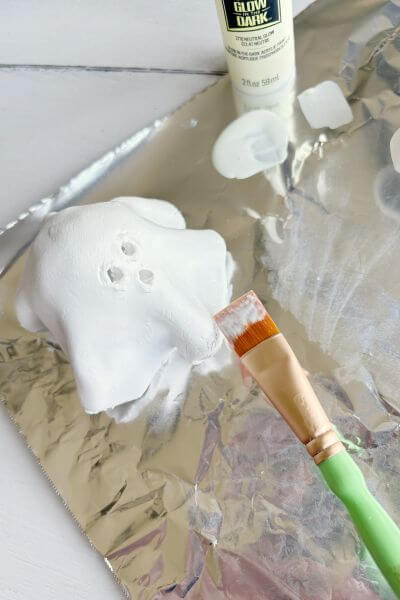 Apply glow in the dark paint using a craft paintbrush. 