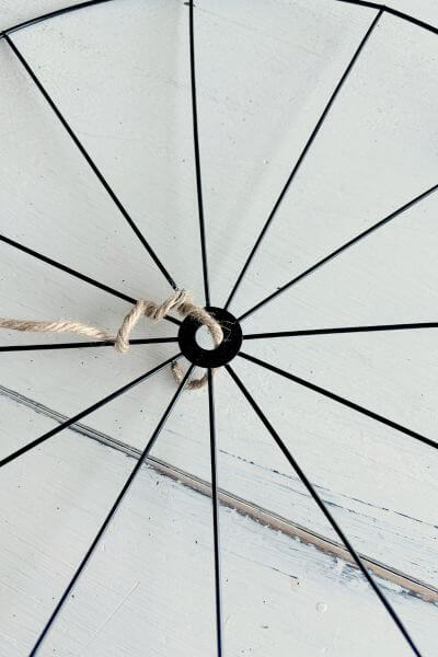 Place jute wire through the hole in the bicycle wheel wreath form. 
