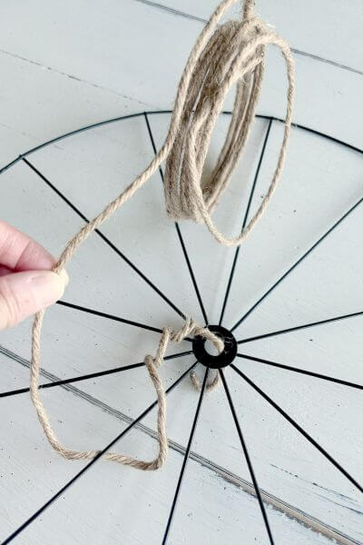 Continue wrapping the jute wire around the spokes in a gradually widening circle. 