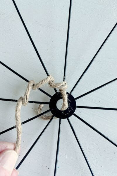 Continue wrapping the jute wire around each spoke in a circular pattern. 