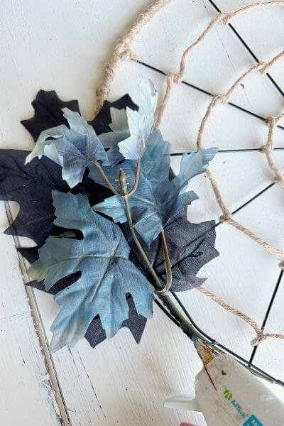 Black and blue maple leaves hot glued to wreath form. 
