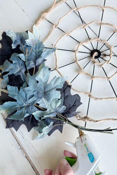 Add the next set of black and blue leaves below the first one. 