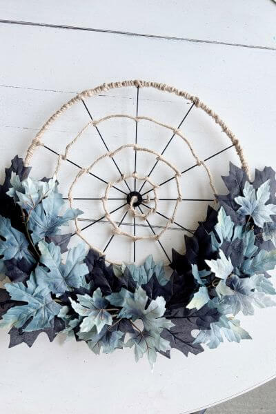 Spider web wreath with leaves added to the bottom. 