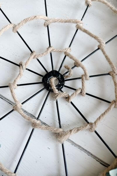Hot glue added to the inner ring of the bicycle wheel wreath form. 