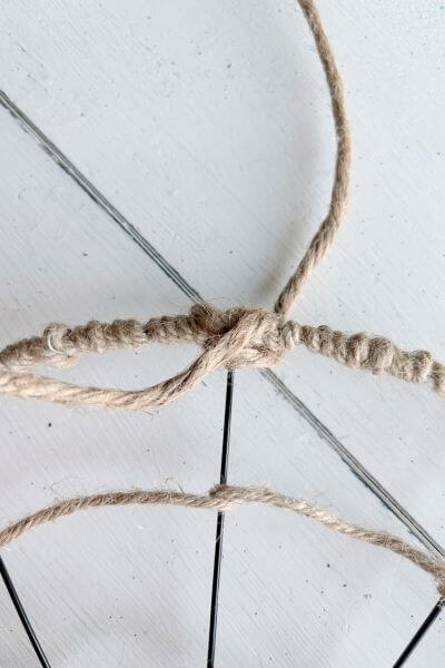 Bring the other end to the front, across and then back through the wire form. 