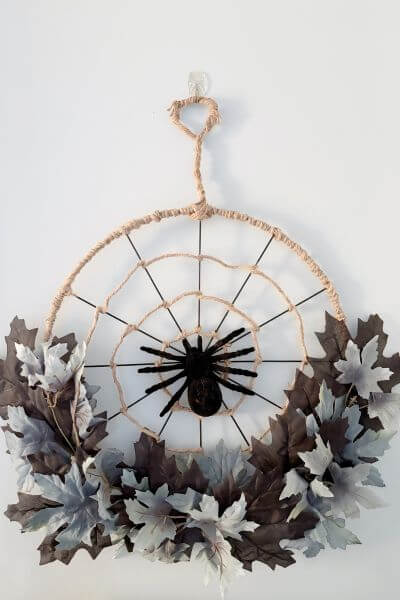 Completed DIY spider web wreath made with Dollar Tree supplies.