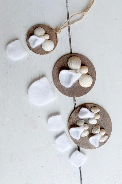 Three angel ornaments with felt beneath each to show size of felt needed for each angel. 