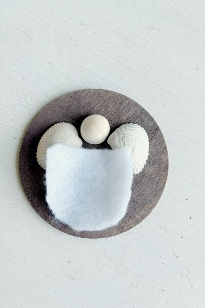 Getting an idea of how the angel will look and fit on the wood round. 