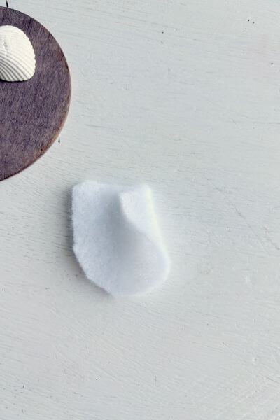 Fold a flap of felt over to the hot glue and secure.