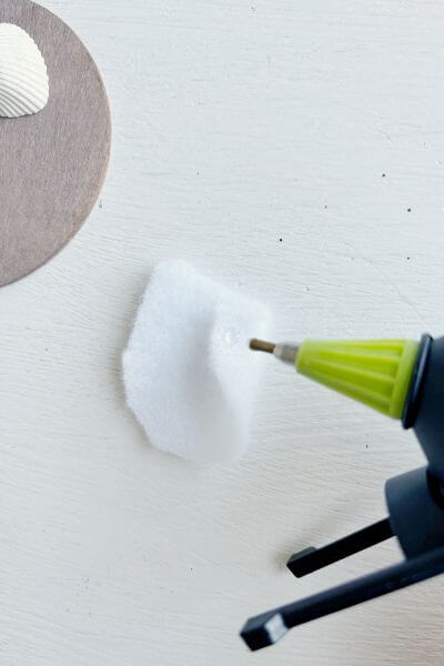 Place a dot of hot glue on top of the fold. 