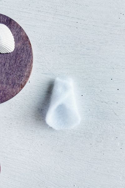 Fold the other side over creating the angel's dress. 