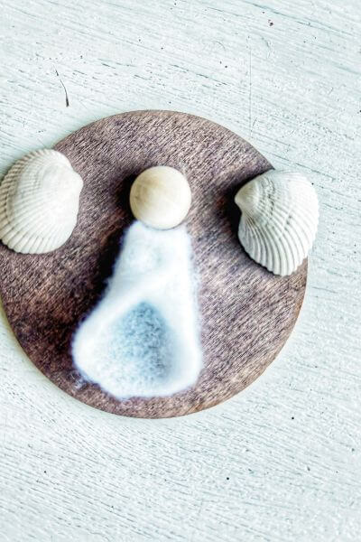 Glue the wood bead head to the wood round first. 