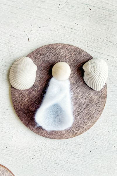 Glue the felt dress to the wood round, butting it up against the wood bead. 