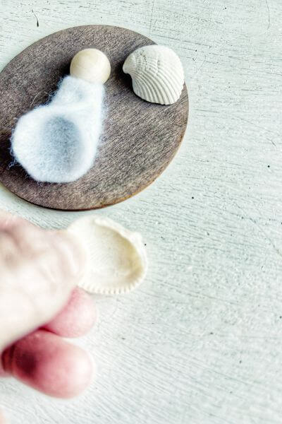 Place hot glue onto the bottom of the seashell. 