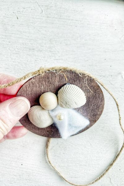 Add the jute twine over the hot glue. 