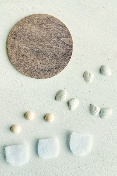 Large wood round, three sets of angel's wings and three pieces of felt. 