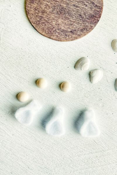 Make three tiny felt angels' dresses first. 