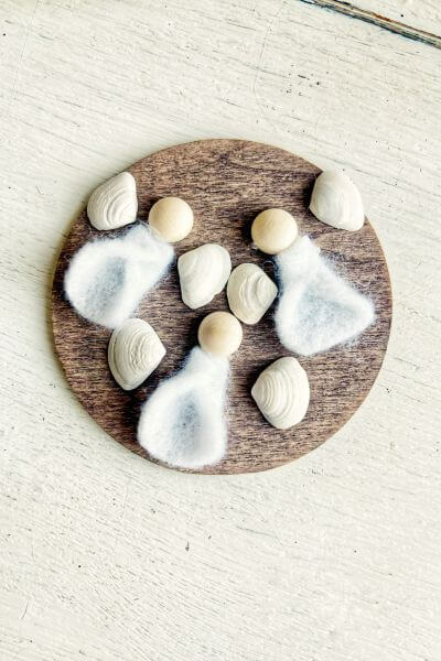 Glue the felt dresses onto the wood round. 