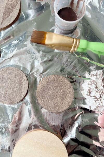 Wood rounds paint washed with Burnt Umber paint color and water. 