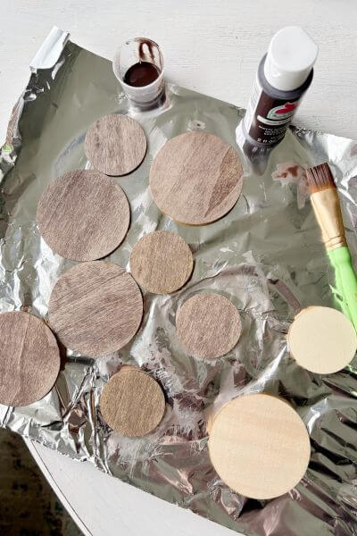 Wood rounds paint washed with Burnt Umber paint and water. 