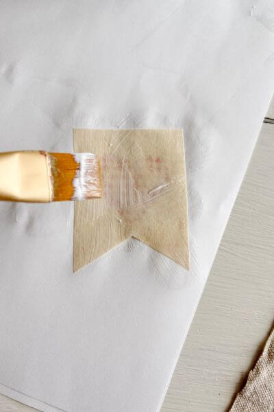 Paint the mod podge on the back of the paper printable.