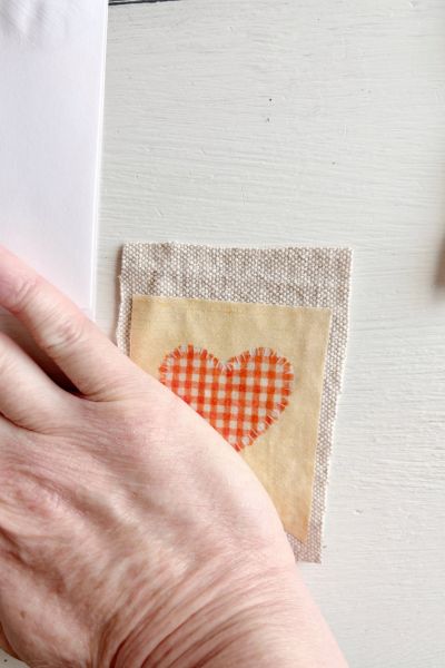 Use the heel of your hand to press the rice paper onto the drop cloth.