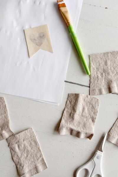 Cut out more drop cloth banner shapes to make the rest of the hearts.