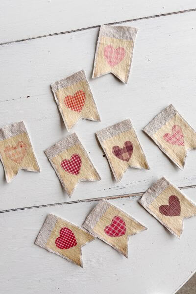 Vintage heart paper printables on drop cloth to make fabric banner.