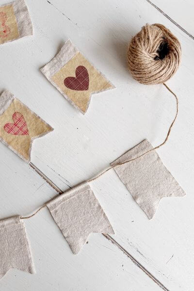 Attaching jute twine to the fabric vintage hearts.