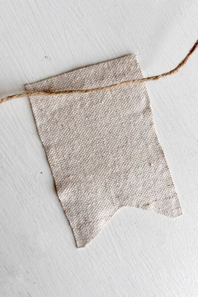 Turn the fabric hearts face down and lay your jute twine along the upper portion.