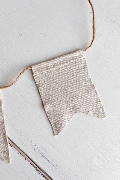 Fold the drop cloth down adhering the edge with the line of hot glue.