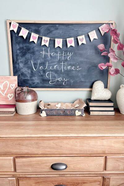 Valentine's Day banner hanging on chalkboard.