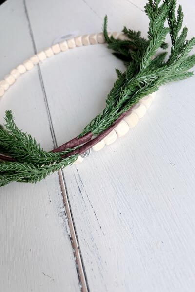 Top of the wood bead wreath with the two pics secured.